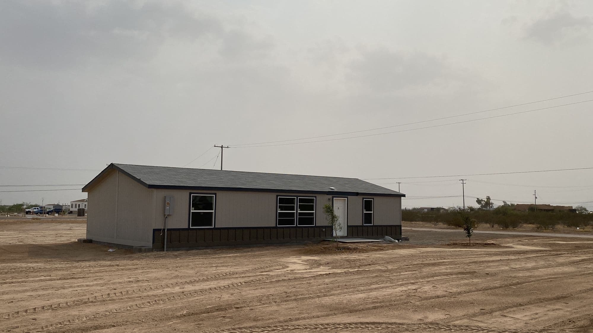 A manufactured home set on a bare lot, ready for finish work